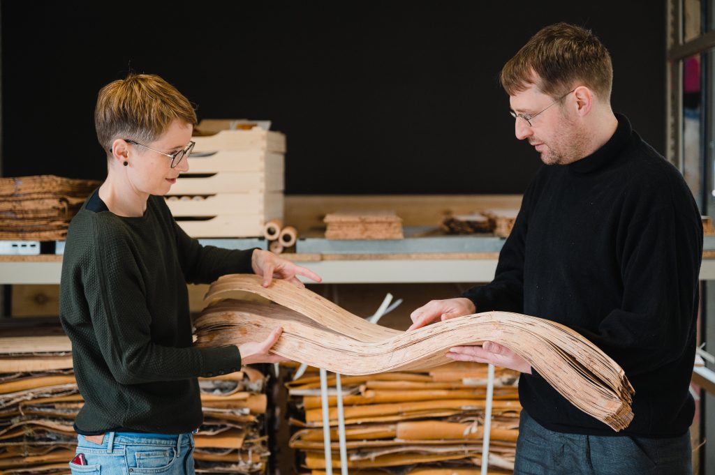 Anne Döring and Tim Mergelsberg holding Nevi's birch bark material, which will be made into handmade boxes, door handles and surfaces.