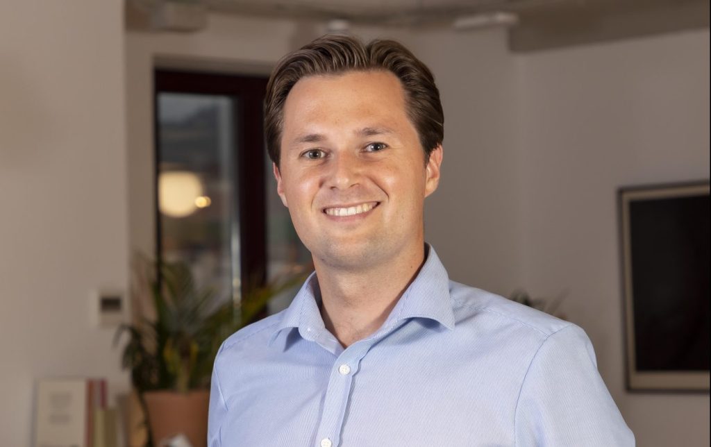 An image of Robert Nowak, investment director at All Iron, which invests in several European edtech startups. He's wearing an ironed blue shirt and smiling