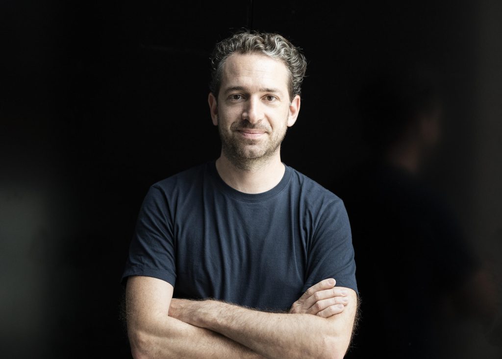 Lucas Polagnoli, founder and managing partner at Calm/Storm Ventures, standing in front of a black background
