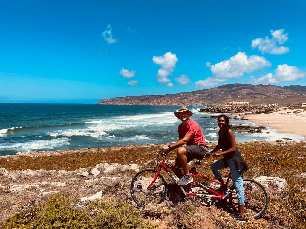 An image of digital nomads Nick Taranto and Nimmi Roche enjoying a bike ride during their family workation in the town of Sintra, Portugal