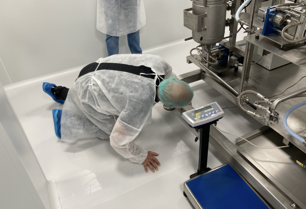 Mike Sassano, founder and CEO of Somai Pharmaceuticals, checking a wrinkle on the floor of the cannabis farm