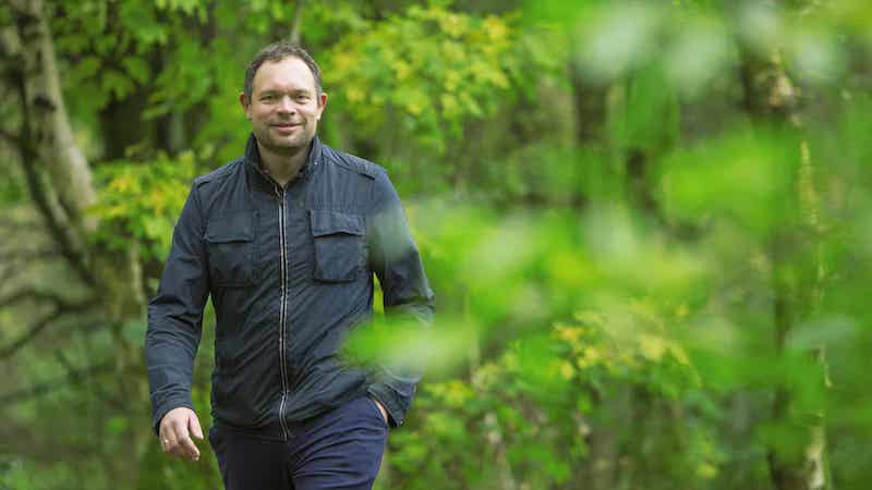 A picture of Jakob Krogsgaard, CEO of Everfuel, walking in the woods.