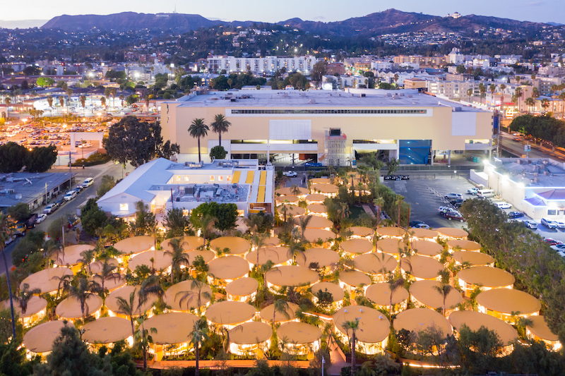 An aerial view of the Second Home Hollywood site, featuring 60 outdoor pods and 6,500 plants, with views of the Hollywood Hills.