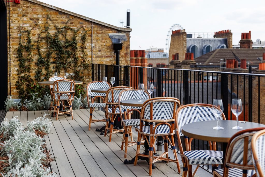 Landscape image of a terrace restaurant overlooking London at the Conduit's
