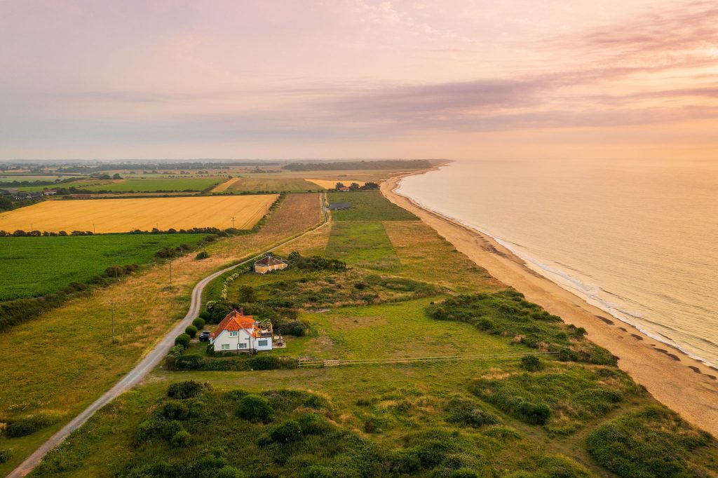 An image of an isolated farmhouse in fields very close to the beach